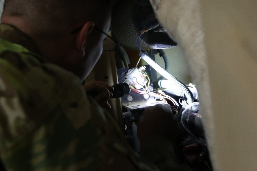 An aviation operations specialist inspects a Hobart ground power unit 